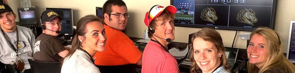 group of Communication Studies students in front of tv and computer monitors