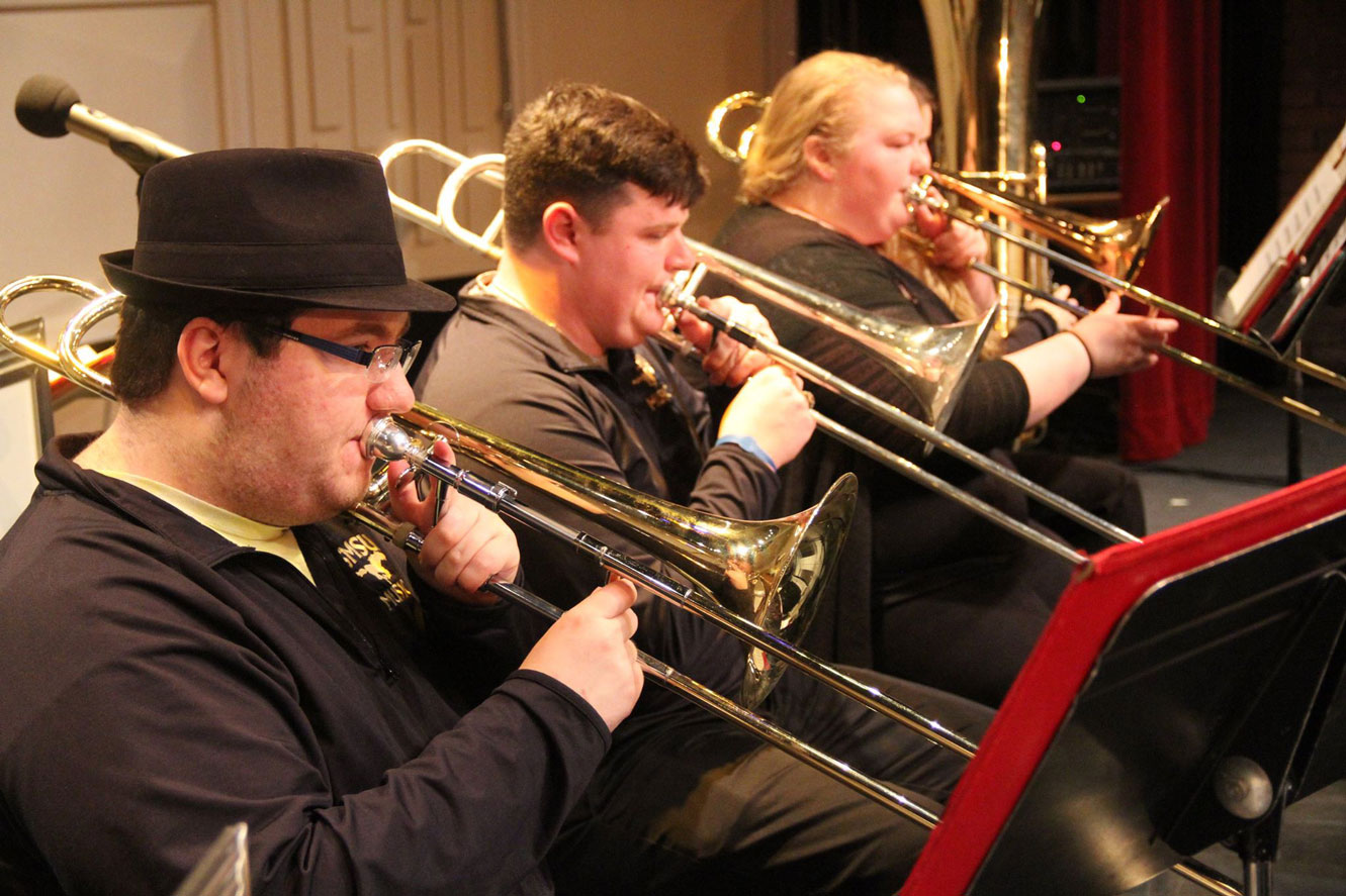 picture of the trombone section from a performance of the Jazz Ensemble